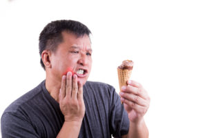 Photo of man suffering intense toothache