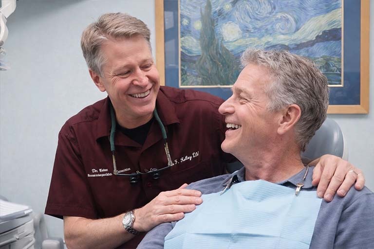 Dentist explaining oral health to patient during consultation highlighting importance of regular dental care and prevention